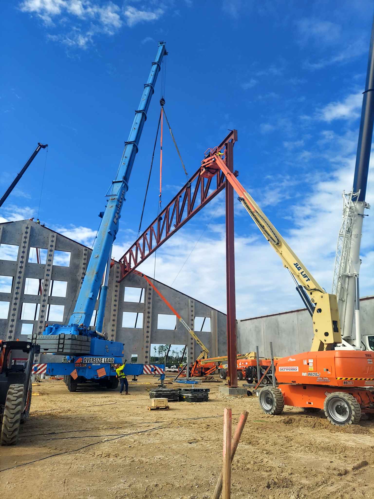 Crane lifting steel truss into position